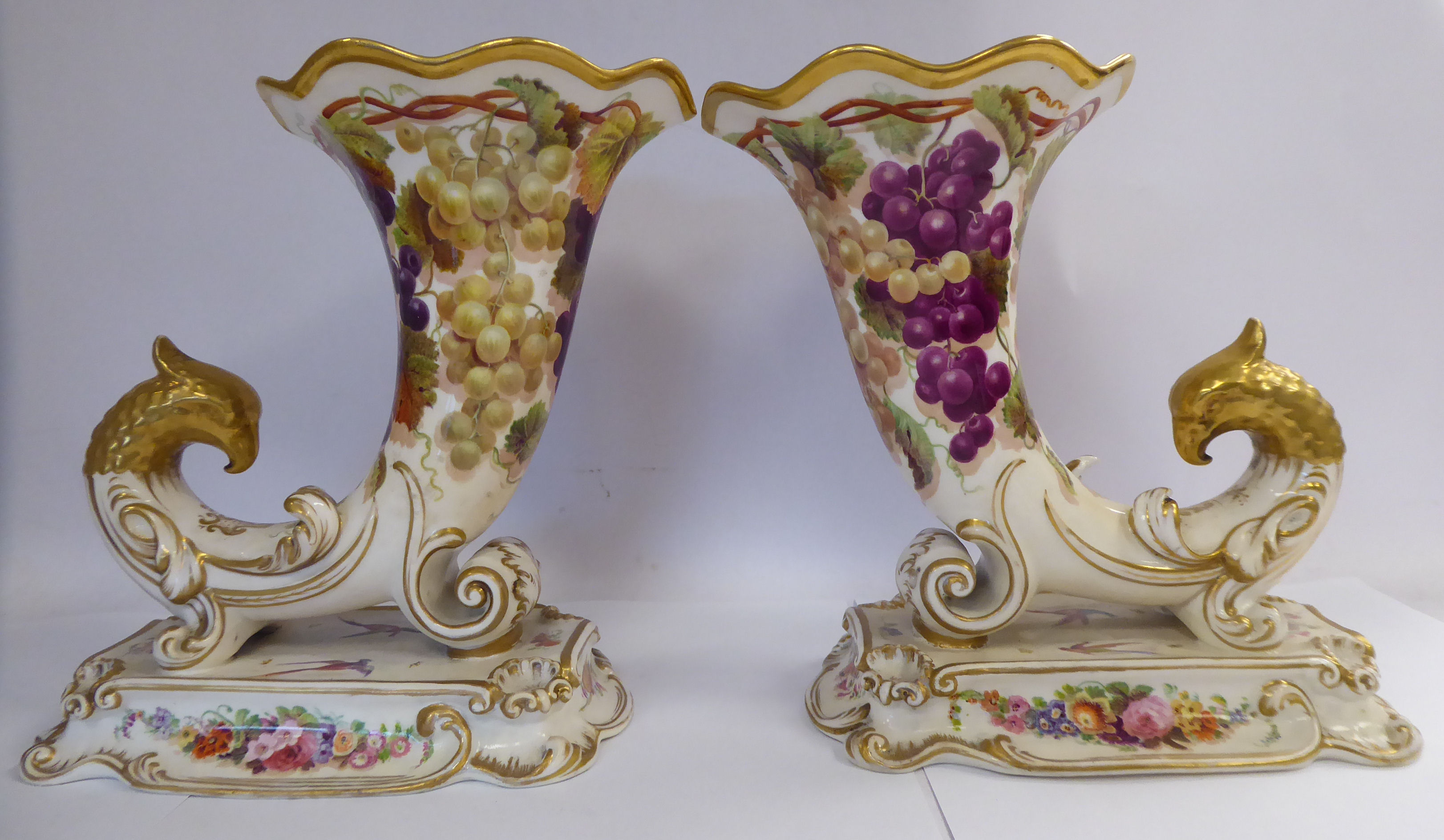 A pair of late Victorian china cornucopia vases with birds' heads,