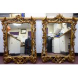 A pair of mid 19thC mirrors, set in carved, gilded,