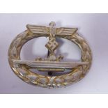 A German U-boat badge, incorporating a spreadeagle and swastika emblem stamped Junker,