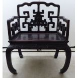 A late 19th/early 20thC Chinese rosewood framed official's chair with a low back and enclosed arms,