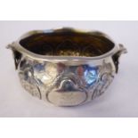 A mid Victorian silver twin handled, footed basin of ogee form, decorated in panels with embossed,