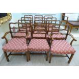 A set of twelve late Victorian mahogany framed dining chairs, the triple serpentine outlined,