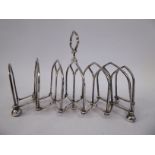 A late 19thC silver plated concertina action letter rack with arched divisions and a central handle