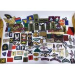 A collection of military Special Forces embroidered and other cloth uniform and other badges,