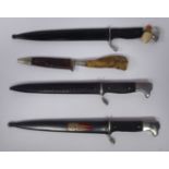 Three similar German miniature bayonets with rivetted handgrips,