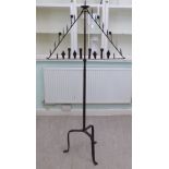 A mid 17thC rustically constructed iron candlestand of triangular design,