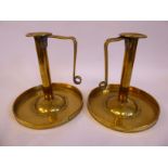 A pair of Arts & Crafts rivetted brass chambersticks,