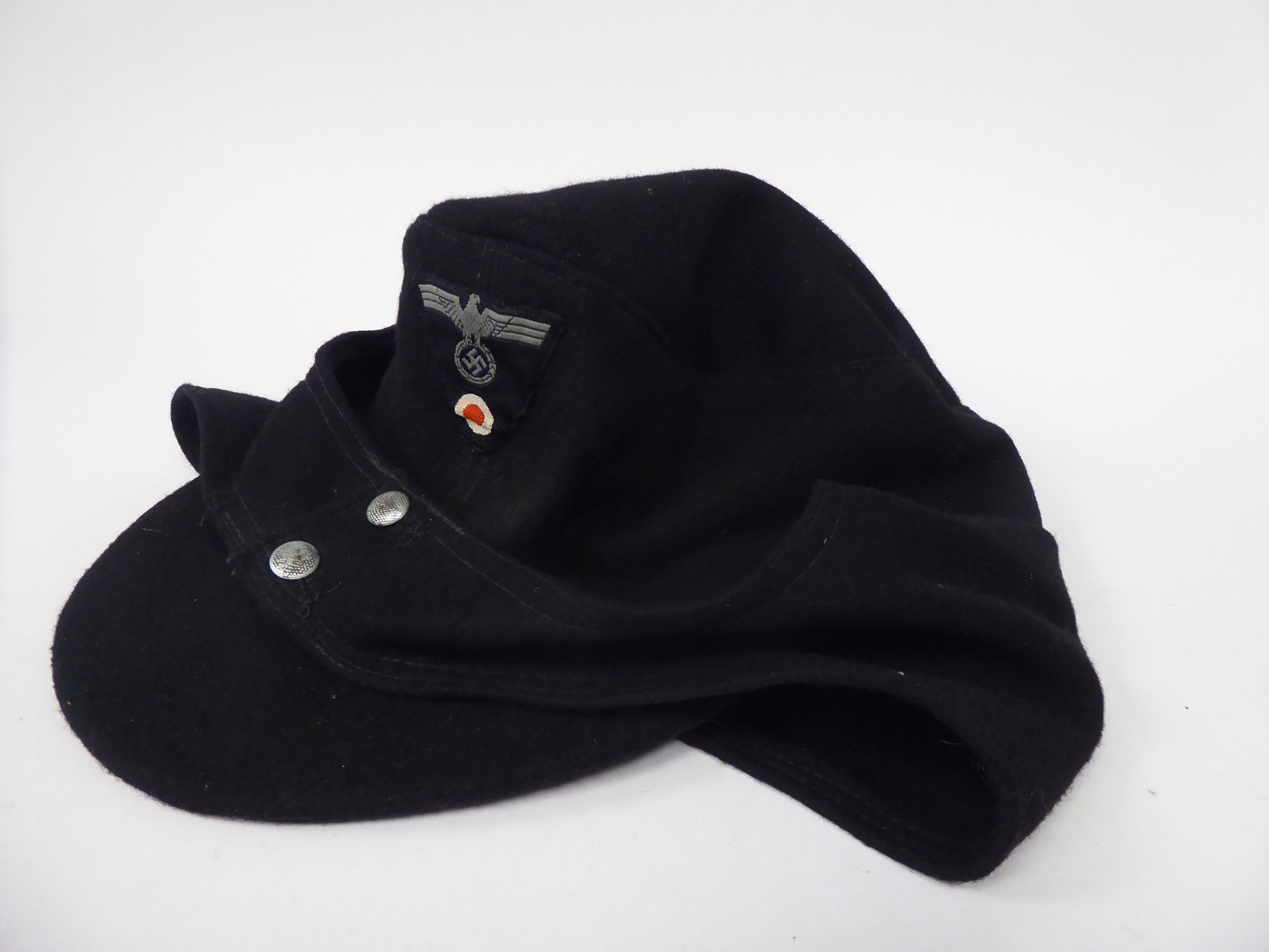 A German army black ski cap with a woven spreadeagle and swastika emblem (Please Note: this lot is