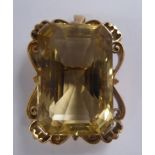 A gold coloured metal framed pendant brooch,