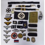 German military related embroidered and other fabric uniform badges, some copies; an SS pay book,