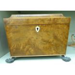 A Regency burr walnut tea caddy of sarcophagus form with a hinged lid,