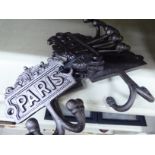 Six cast metal coat hooks stamped 'Paris' OS4