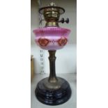 A late Victorian style lacquered brass and opaque black glass table lamp,