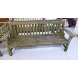 A modern teak garden bench with a slatted back and seat,