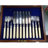 A set of six early 20thC silver plated dessert knives and forks,