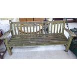 A modern teak garden bench with a slatted back and seat,