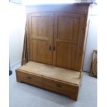 A modern waxed pine wardrobe with a fixed cornice,