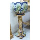 A late 19th/early 20thC (possibly Majolica) china jardiniere and pedestal,