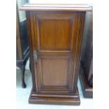 An Edwardian mahogany pot cupboard with a single panelled door,