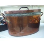 A late 19thC copper fish kettle and cover with opposing rivetted handles 11''h 22''w CS