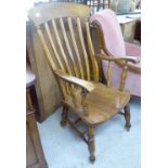 A late 19thC beech and elm framed lath back Windsor elbow chair,