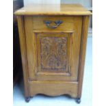 An Edwardian mahogany perdonium with a carved panelled front,