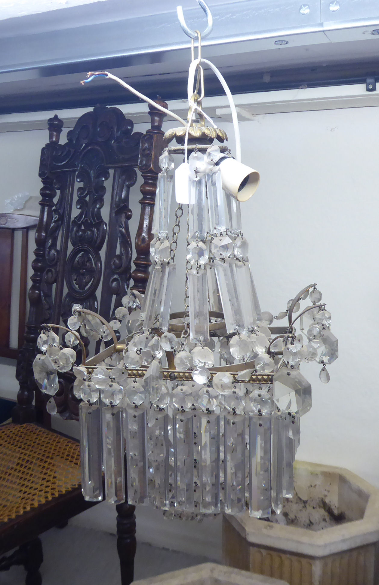 A mid 20thC gilt metal bag design centre light fitting with multiple cut glass drops 21''h