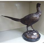 A cast and patinated bronze sculpture, a pheasant,