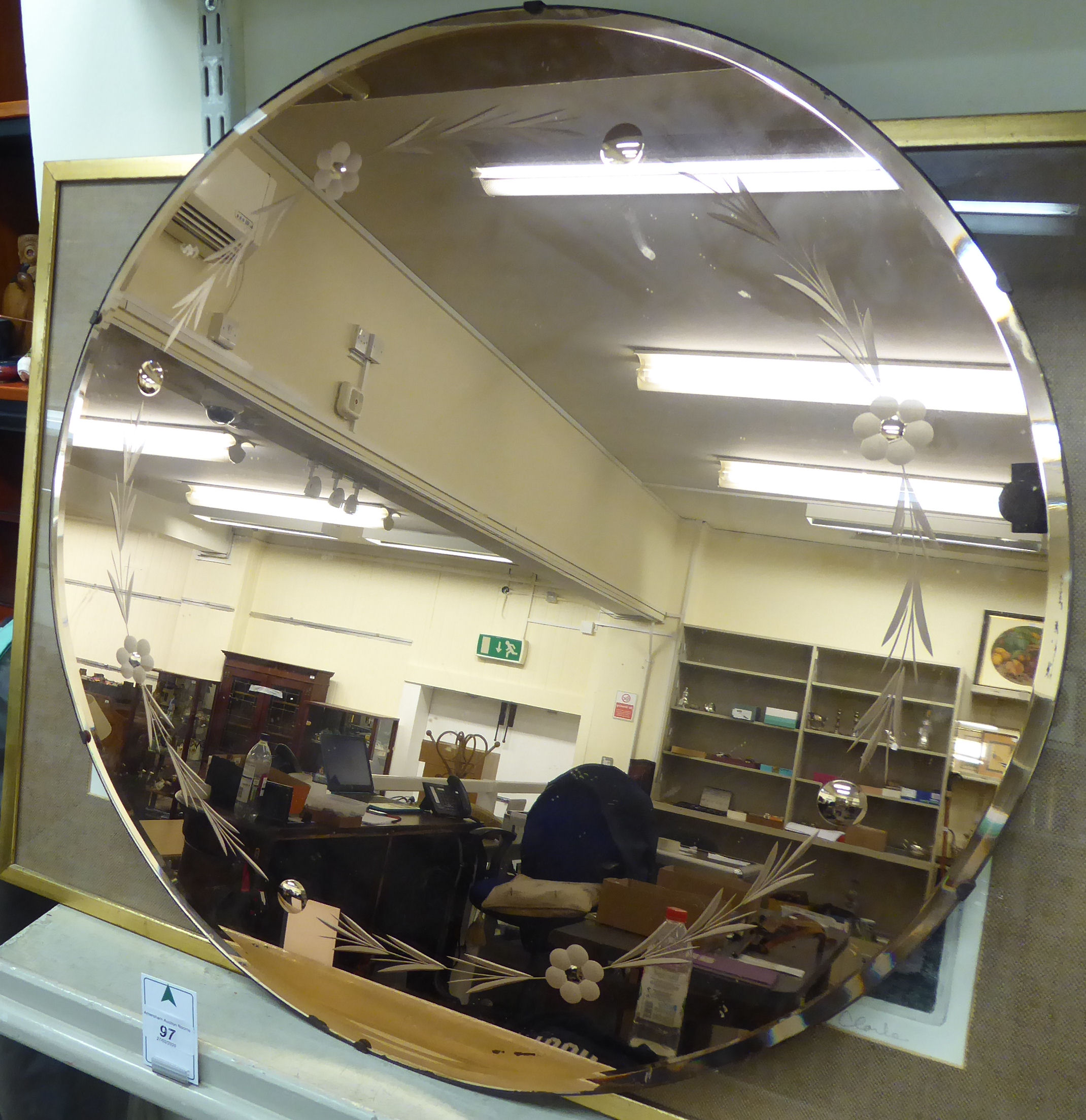 A 1950s bronzed and engraved bevelled mirror 24''dia HSR