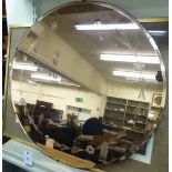 A 1950s bronzed and engraved bevelled mirror 24''dia HSR