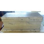 An early 20thC rustically constructed pine box with straight sides and a hinged lid,