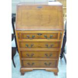 A modern lady's yewwood finished bureau,