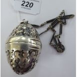 A Continental silver coloured metal ovoid shaped pomander with a hinged cover,