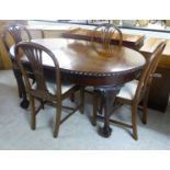 A 1930s mahogany Georgian style wind-out dining table, the top with a reed moulded edge,