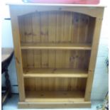 A modern honey coloured pine, open front bookcase,