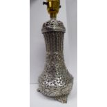 An Indian silver coloured metal table lamp, ornately cast,