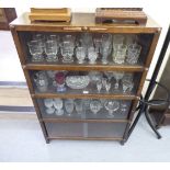 A 1930s stained oak, four section cabinet bookcase, enclosed by sliding glass doors 50''h 33.