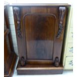 A mid Victorian flame mahogany finished pedestal cupboard with a panelled door,