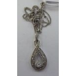 A 9ct white gold and diamond set pendant,