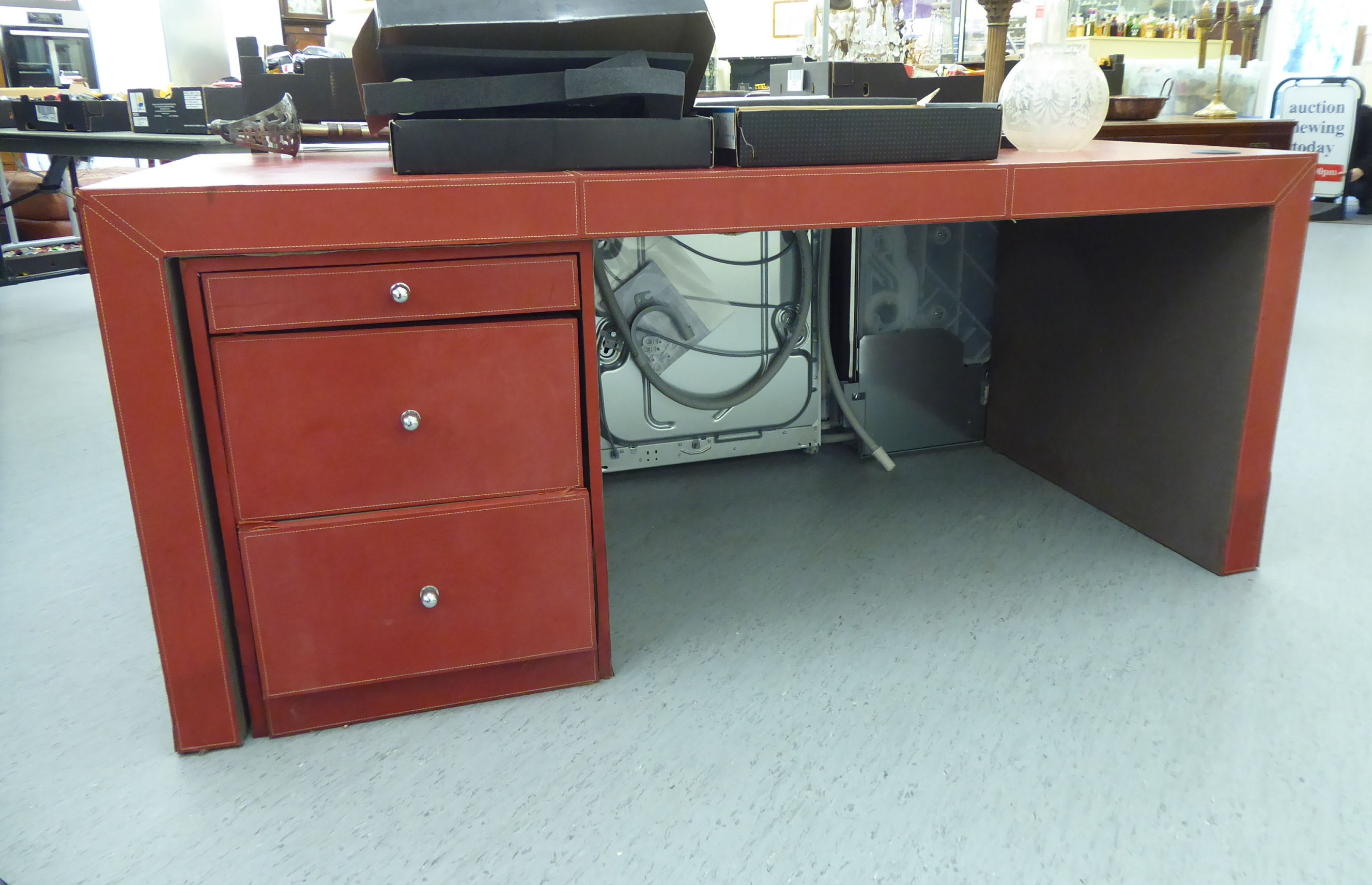 A modern red hide covered desk,