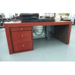 A modern red hide covered desk,