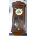 An early/mid stained oak cased wall clock;