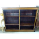 An Edwardian mahogany open front dwarf bookcase with two banks of two open shelves,