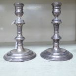 A pair of Georgian style silver candlesticks,