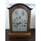 An early 20thC string inlaid mahogany mantle clock,