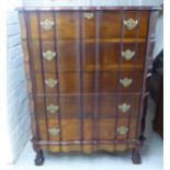 A mid 20thC mahogany finished, serpentine front, six drawer dressing chest,