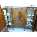 A mid 20thC mahogany breakfront display cabinet with a central panelled door,