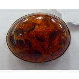 A silver coloured metal amber oval brooch 11