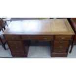 An early 20thC mahogany nine drawer, twin pedestal desk,