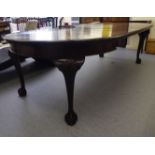 A 1930s Georgian style mahogany wind-out dining table, the two D-ends raised on substantial legs,